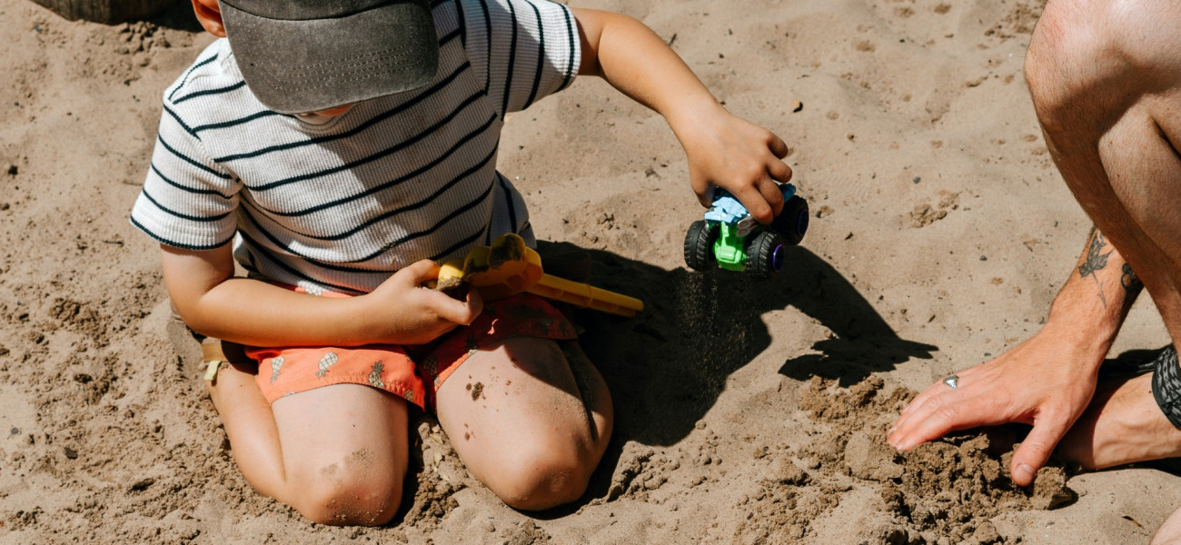 Older Kid Playing on beach 2560x890 Header Image
